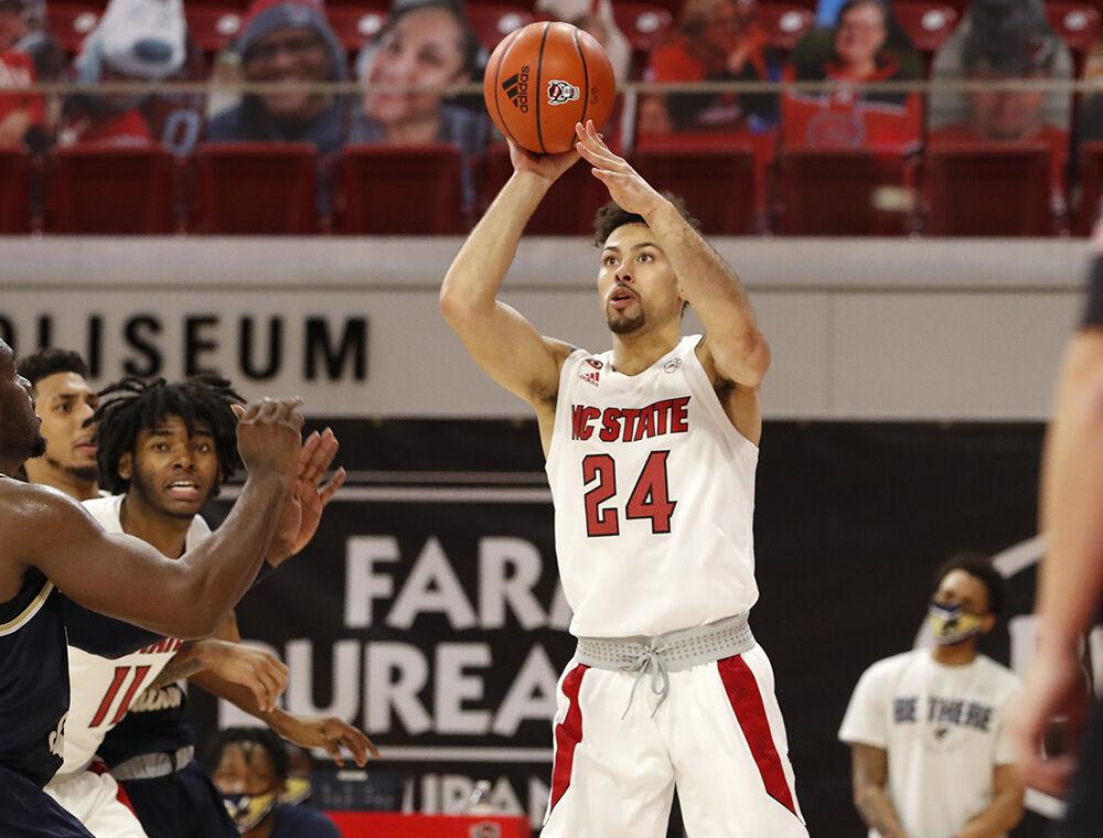 N.C. State's Devon Daniels (24) shoots during N.C. State&#8217;s game against Charleston Southern in the Wolfpack Invitational at Reynolds Coliseum in Raleigh, N.C., Wednesday, Nov. 25, 2020.