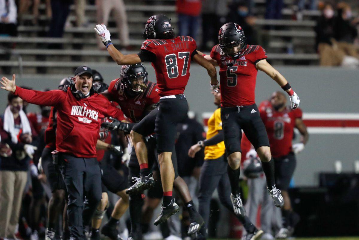 N.C. State&#8217;s Anthony Smith (87) celebrates with Thayer Thomas (5) after Smith recovered a fumble during the second half of N.C. State&#8217;s 38-22 victory over Florida State at Carter-Finley Stadium in Raleigh, N.C., Saturday, Nov. 14, 2020.