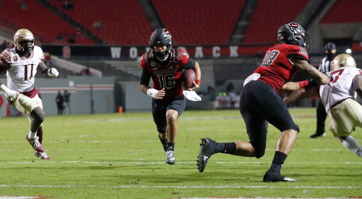 N.C. State quarterback Bailey Hockman (16) scores a touchdown on a 4-yard run during the first half of N.C. State&#8217;s game against Florida State at Carter-Finley Stadium in Raleigh, N.C., Saturday, Nov. 14, 2020.