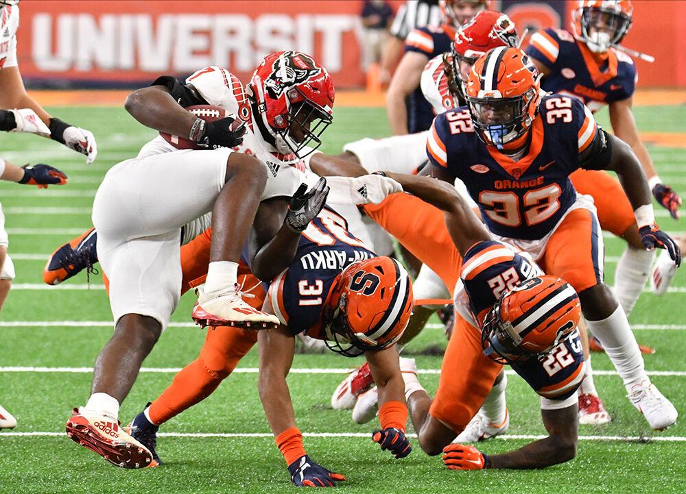Nov 28, 2020; Syracuse, New York, USA; North Carolina State Wolfpack running back Zonovan Knight (7) is tackled by Syracuse Orange linebacker Geoff Cantin-Arku (31) on a kickoff return in the second quarter at the Carrier Dome. Mandatory Credit: Mark Konezny-USA TODAY Sports