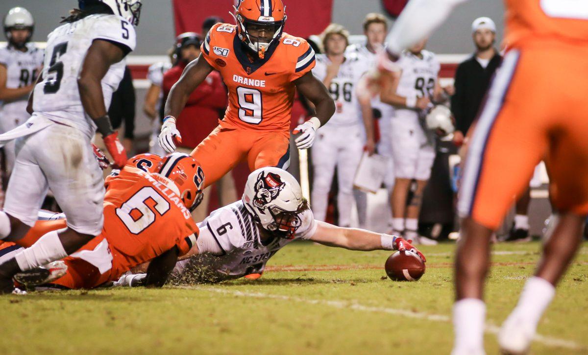 NC State redshirt junior tight end Cary Angeline reaches to collect the ball he'd fumbled after a 30-yard reception. NC State hosted the Syracuse Orange on Thursday, October 10, 2019. NC State won the game 16-10. Angeline had two catches on the day for a total of 31 yards.