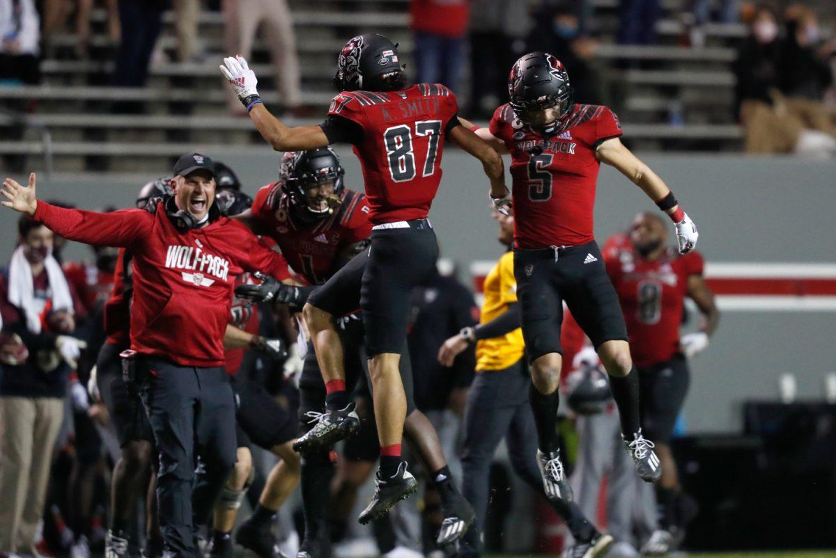 N.C. State&#8217;s Anthony Smith (87) celebrates with Thayer Thomas (5) after Smith recovered a fumble during the second half of N.C. State&#8217;s 38-22 victory over Florida State at Carter-Finley Stadium in Raleigh, N.C., Saturday, Nov. 14, 2020.