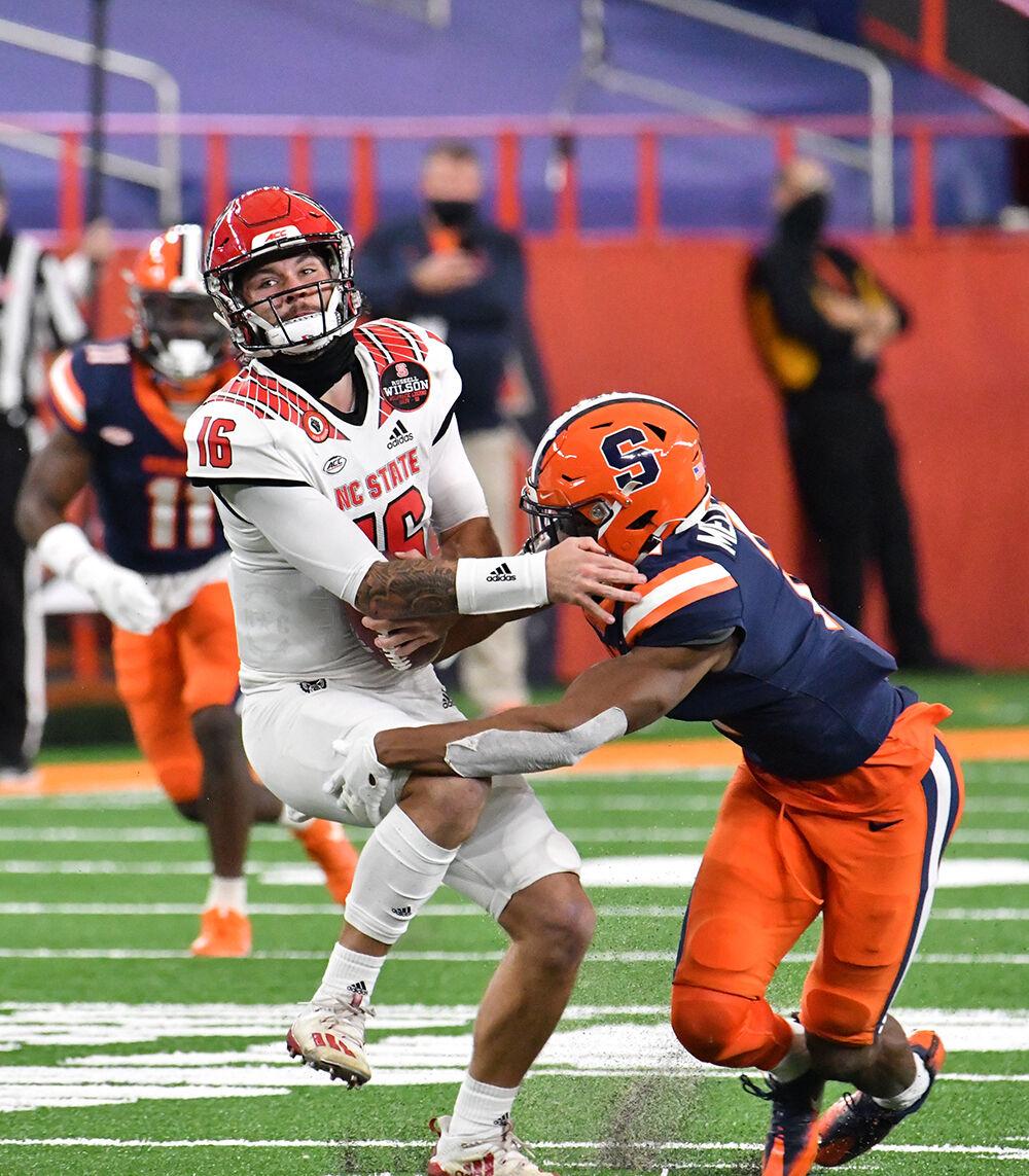 Nov 28, 2020; Syracuse, New York, USA;North Carolina State Wolfpack quarterback Bailey Hockman (16) is sacked by Syracuse Orange defensive back Ifeatu Melifonwu (2) in the second quarter at the Carrier Dome. Mandatory Credit: Mark Konezny-USA TODAY Sports