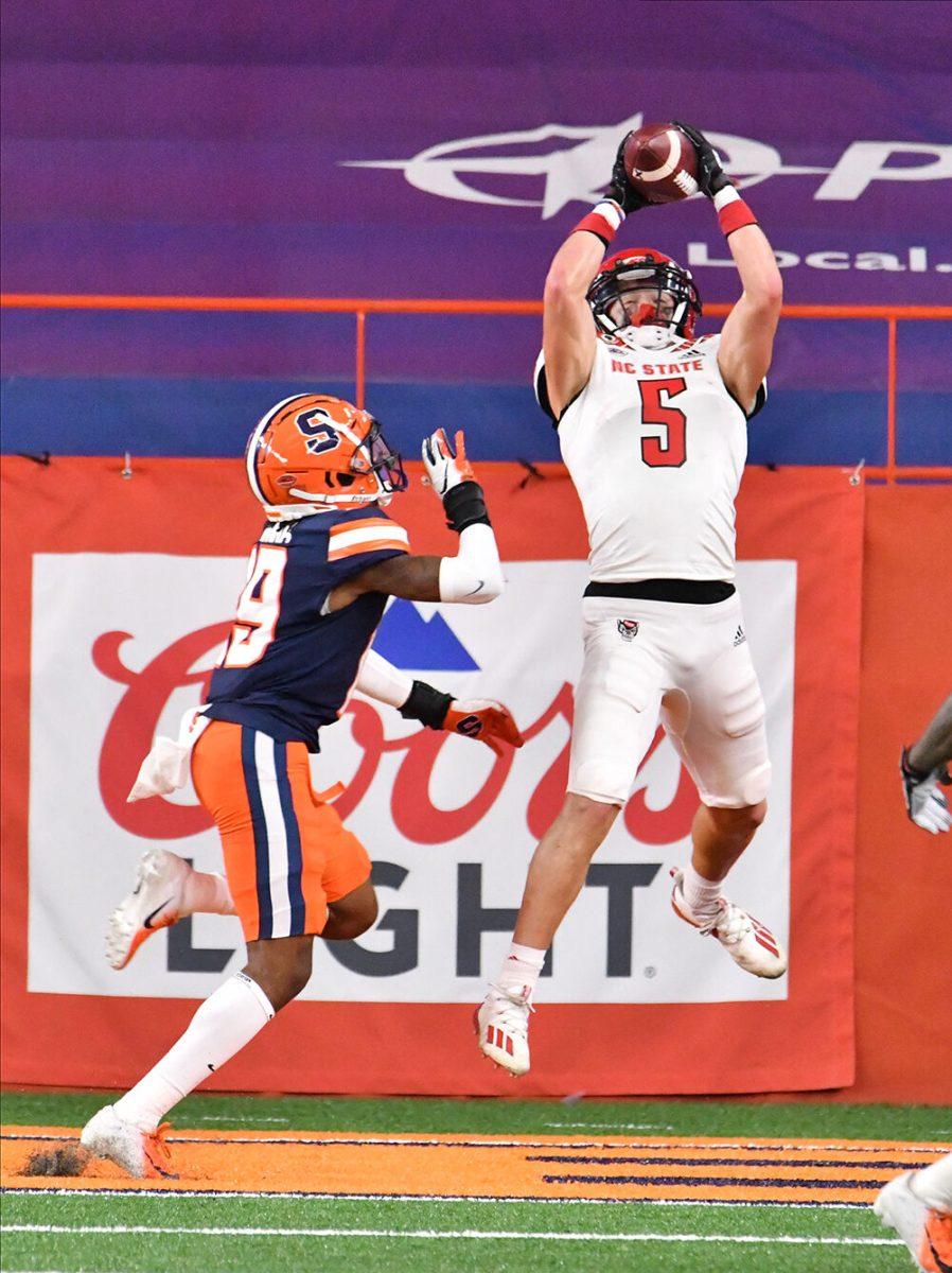 Nov 28, 2020; Syracuse, New York, USA; North Carolina State Wolfpack wide receiver Thayer Thomas (5) catches a touchdown pass in front of Syracuse Orange defensive back John Sweetwood (29) in the second quarter at the Carrier Dome. Mandatory Credit: Mark Konezny-USA TODAY Sports