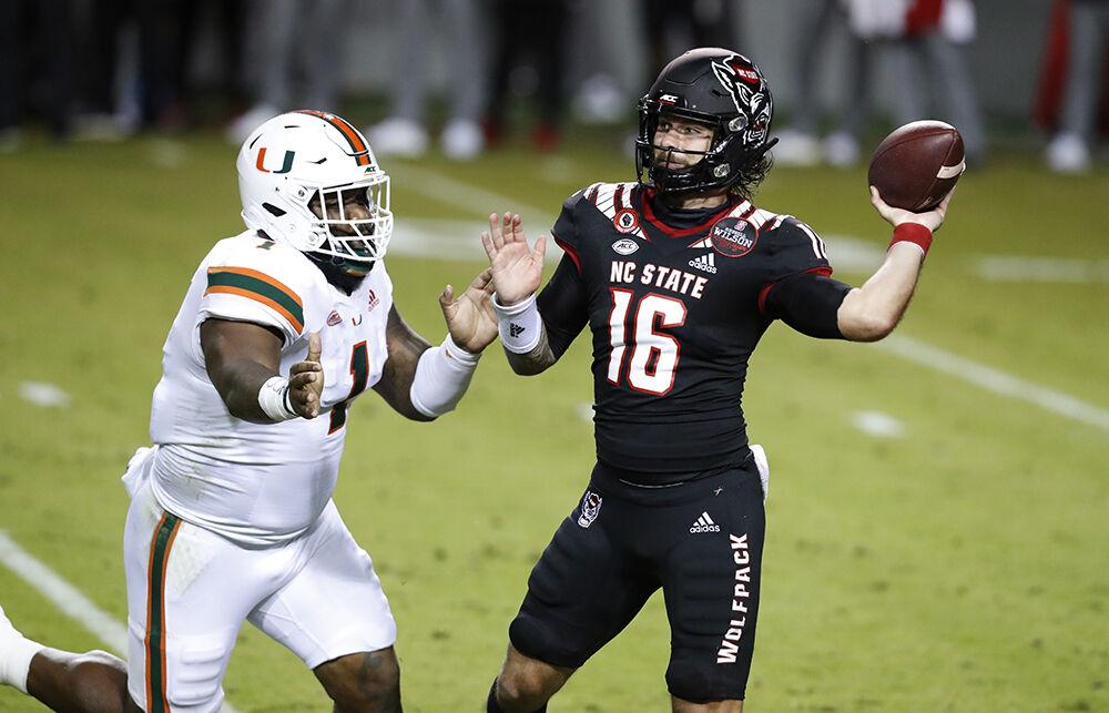 N.C. State quarterback Bailey Hockman (16) prepares to pass while pressured by Miami defensive lineman Nesta Jade Silvera (1) during the first half of N.C. State&#8217;s game against Miami at Carter-Finley Stadium in Raleigh, N.C., Friday, Nov. 6, 2020.