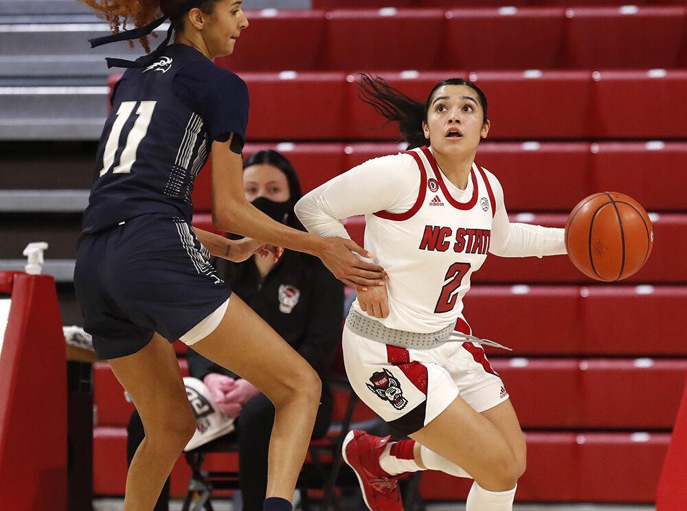 N.C. State's Raina Perez (2) drives around North Florida's Jazz Bond (11) during the first half of N.C. State&#8217;s game against North Florida at Reynolds Coliseum in Raleigh, N.C., Wednesday, Nov. 25, 2020.
