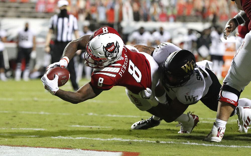 N.C. State running back Ricky Person Jr. (8) scores on a three-yard touchdown run as Wake Forest linebacker Ryan Smenda Jr. (5) defends during the second half of N.C. State's 45-42 victory over Wake Forest at Carter-Finley Stadium in Raleigh, N.C, Saturday, Sept. 19, 2020.