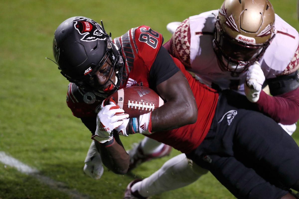 N.C. State wide receiver Emeka Emezie (86) scores on a 21-yard touchdown reception as Florida State linebacker Emmett Rice (1) defends during the first half of N.C. State&#8217;s game against Florida State at Carter-Finley Stadium in Raleigh, N.C., Saturday, Nov. 14, 2020.