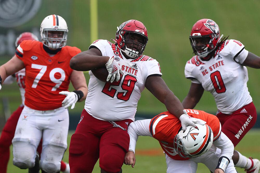 ERIN EDGERTON/THE DAILY PROGRESS DUPLICATE North Carolina State Wolfpack defensive tackle Alim McNeill (29) scores a touch down during a game against North Carolina State Wolfpack on Saturday at Scott Stadium in Charlottesville. N.C State defeated UVa 38-21.