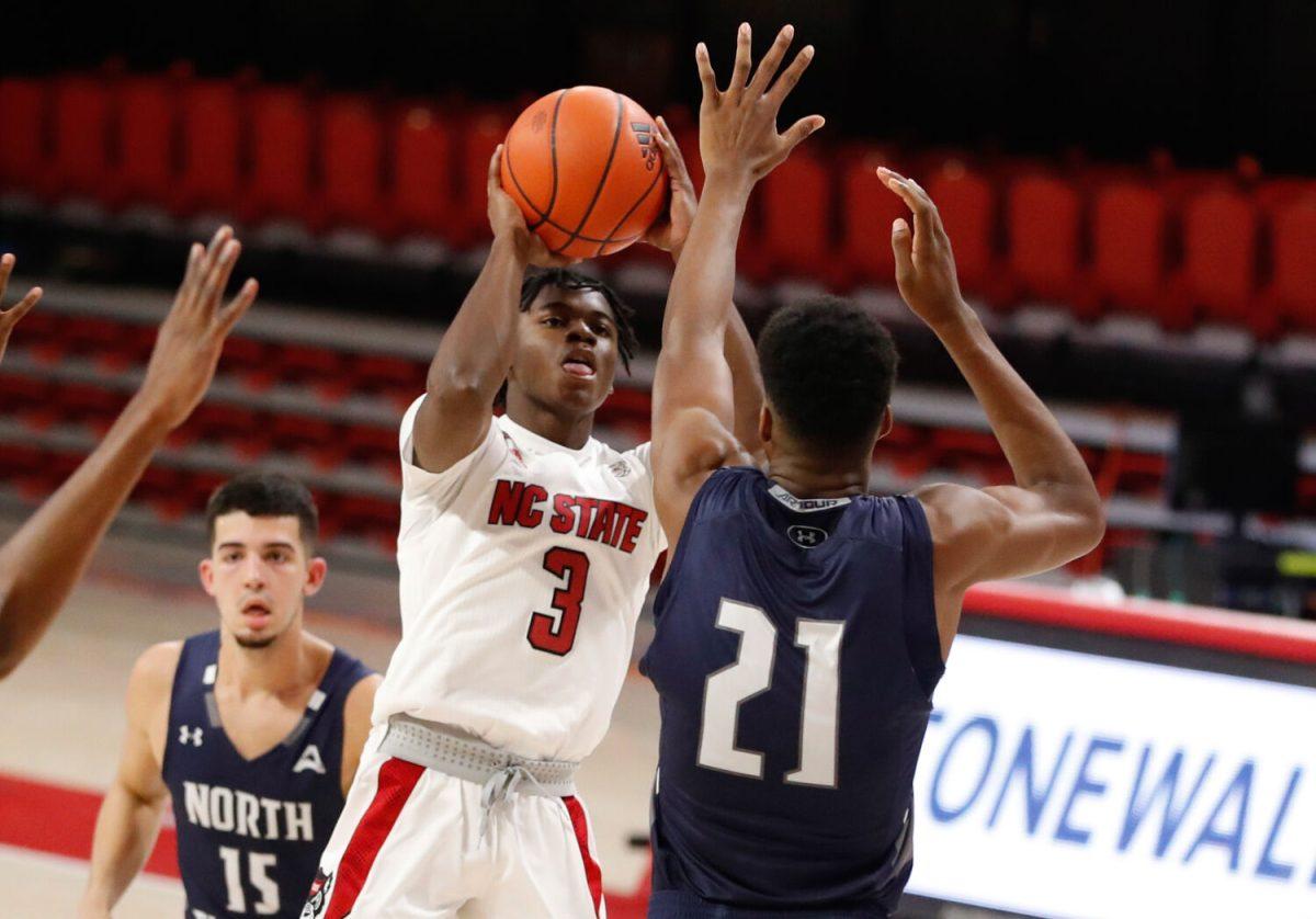 N.C. State's Cam Hayes (3) shoots as North Florida's Jonathan Aybar (21) defends during the second half of N.C. State&#8217;s 86-51 victory over North Florida in the Mako Medical Wolfpack Invitational at Reynolds Coliseum in Raleigh, N.C., Friday, Nov. 27, 2020.