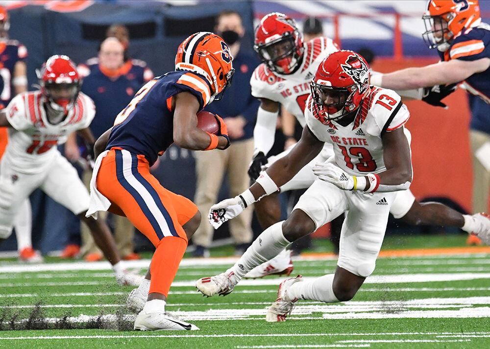 Nov 28, 2020; Syracuse, New York, USA; North Carolina State Wolfpack defensive back Tyler Baker-Williams (13) prepares to makes a tackle on Syracuse Orange wide receiver Taj Harris (3) in the first quarter at the Carrier Dome. Mandatory Credit: Mark Konezny-USA TODAY Sports
