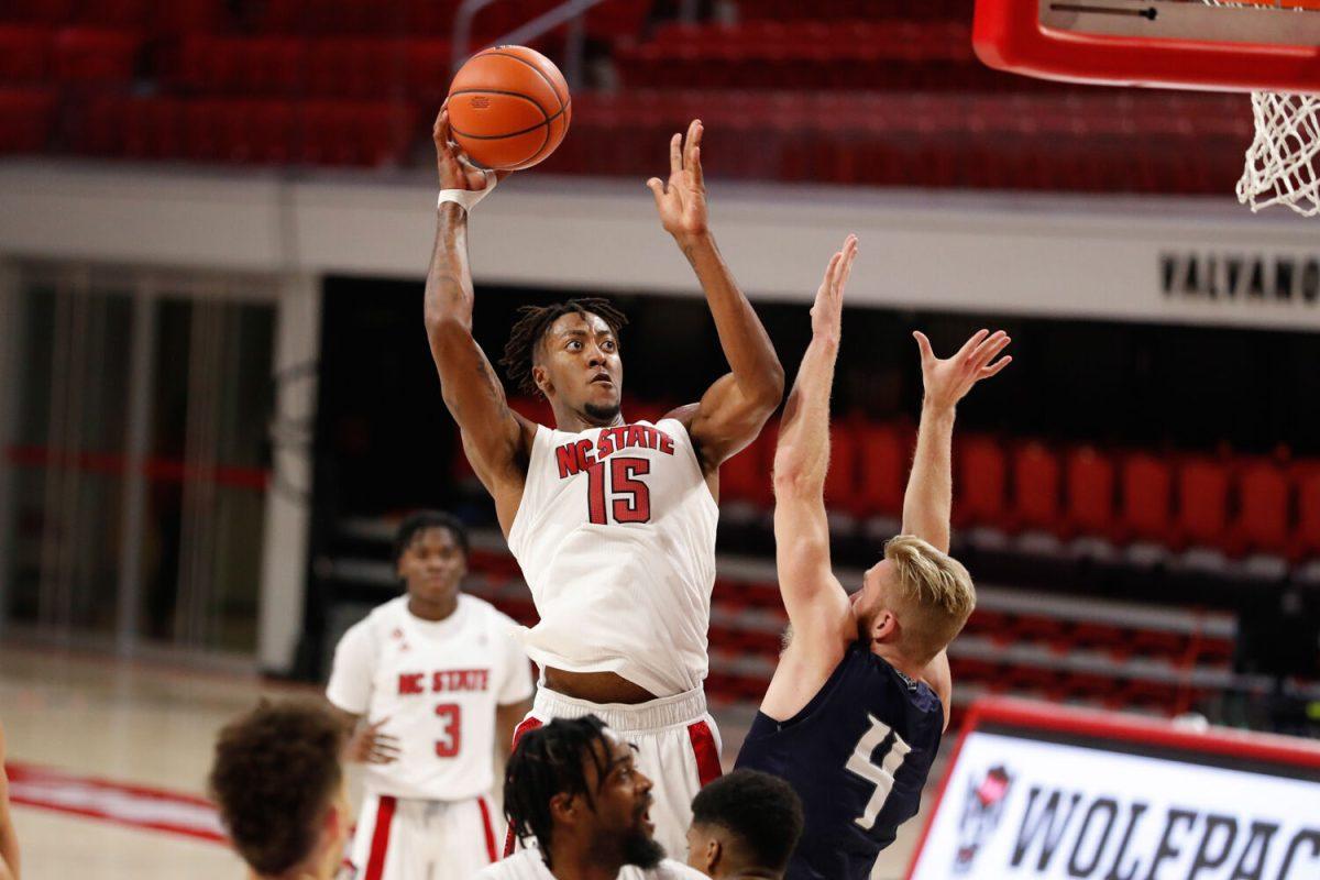 N.C. State's Manny Bates (15) shoots as North Florida's Josh Endicott (4) defends during the second half of N.C. State&#8217;s 86-51 victory over North Florida in the Mako Medical Wolfpack Invitational at Reynolds Coliseum in Raleigh, N.C., Friday, Nov. 27, 2020.