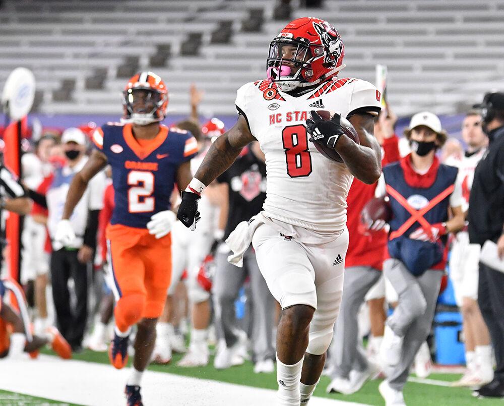 Nov 28, 2020; Syracuse, New York, USA; North Carolina State Wolfpack running back Ricky Person Jr. (8) runs after making a catch as Syracuse Orange defensive back Ifeatu Melifonwu (2) pursues in the first quarter at the Carrier Dome. Mandatory Credit: Mark Konezny-USA TODAY Sports