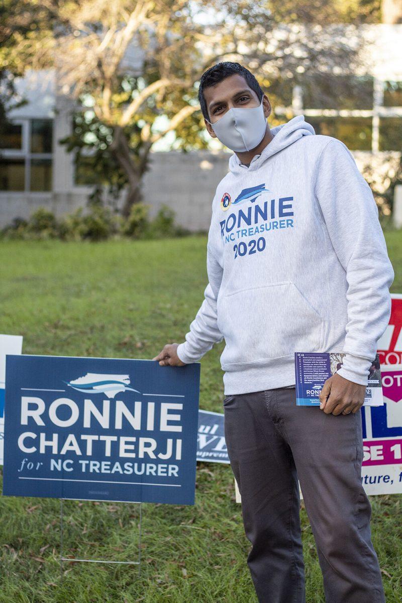 Ronnie Chatterji, who is running for NC State Treasurer, poses in front of his campaign sign outside of Pullen Community on Tuesday, Nov. 3, 2020.