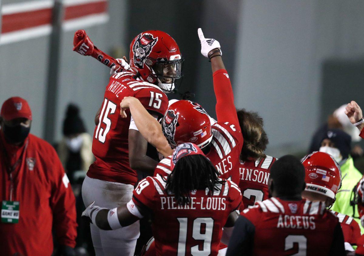 N.C. State cornerback Aydan White (15) celebrates with the turnover bone after intercepting the ball during the second half of N.C. State&#8217;s 15-14 victory over Liberty at Carter-Finley Stadium in Raleigh, N.C., Saturday, Nov. 21, 2020.