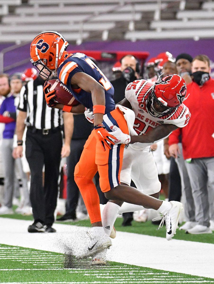 Nov 28, 2020; Syracuse, New York, USA; North Carolina State Wolfpack cornerback Shyheim Battle (25) makes a tackle on Syracuse Orange wide receiver Taj Harris (3) in the first quarter at the Carrier Dome. Mandatory Credit: Mark Konezny-USA TODAY Sports
