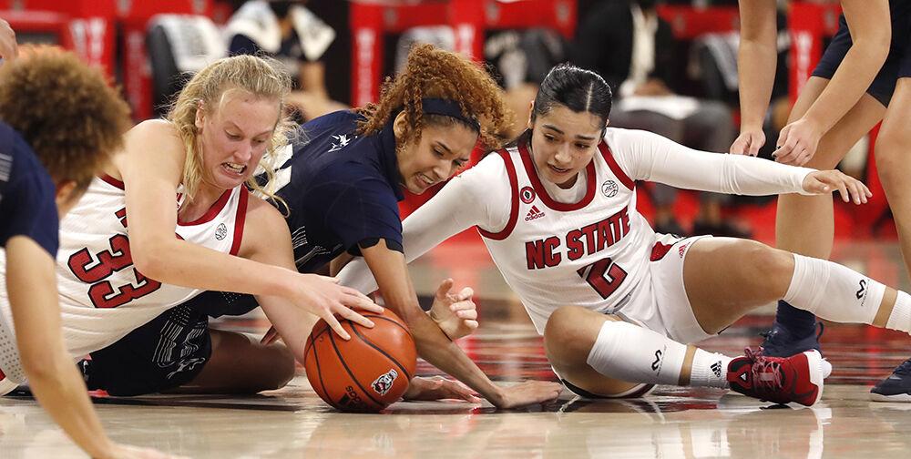 From left, N.C. State's Elissa Cunane (33), North Florida's Jazz Bond (11) and N.C. State's Raina Perez (2) go after the loose ball during the first half of N.C. State&#8217;s game against North Florida at Reynolds Coliseum in Raleigh, N.C., Wednesday, Nov. 25, 2020.