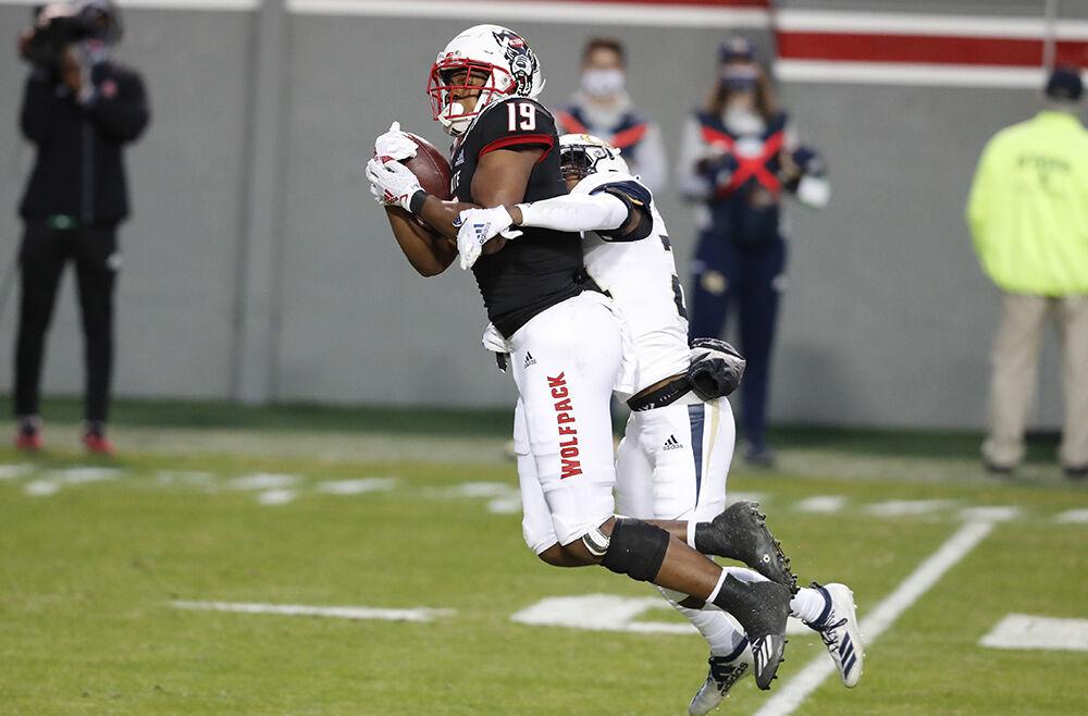 N.C. State wide receiver C.J. Riley (19) pulls in a reception while defended by Georgia Tech defensive back Kenan Johnson (24) during the first half of N.C. State&#8217;s game against Georgia Tech at Carter-Finley Stadium in Raleigh, N.C., Saturday, Dec. 5, 2020.