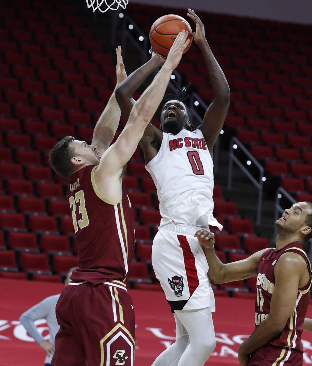 N.C. State's D.J. Funderburk (0) shoots as Boston College's James Karnik (33) defends during the first half of N.C. State&#8217;s game against Boston College at PNC Arena in Raleigh, N.C., Wednesday, December 30, 2020.