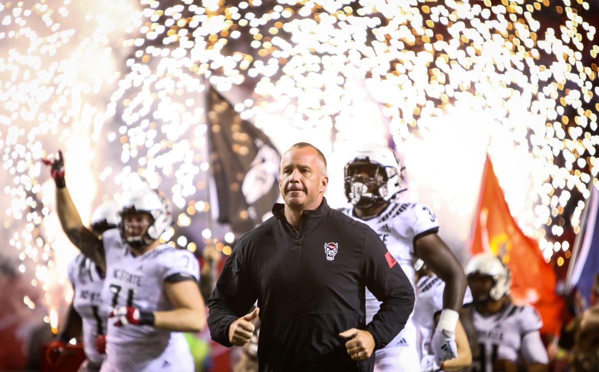 Head coach Dave Doeren takes the field with the team before the start of the game against the Syracuse Orange on Thursday, October 10, 2019. NC State won the game 16-10.