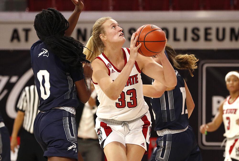 N.C. State's Elissa Cunane (33) heads to shoot as North Florida's Elise Harden (0) defends during the first half of N.C. State&#8217;s game against North Florida at Reynolds Coliseum in Raleigh, N.C., Wednesday, Nov. 25, 2020.
