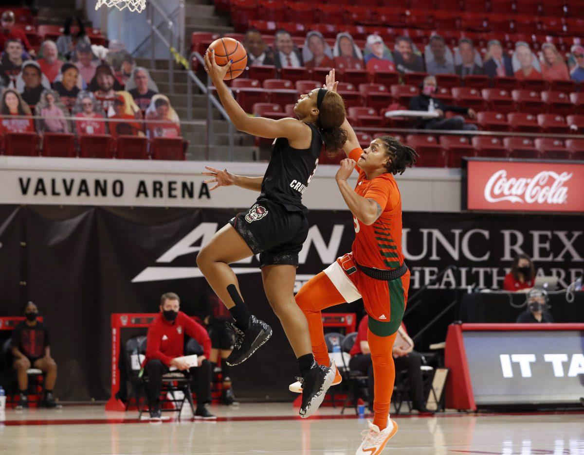 N.C. State's Kai Crutchfield (3) goes up for the basket past the defense of Miami's Destiny Harden (3) during the second half of N.C. State&#8217;s 78-47 victory over Miami at Reynolds Coliseum in Raleigh, N.C., Sunday, Dec. 20, 2020.