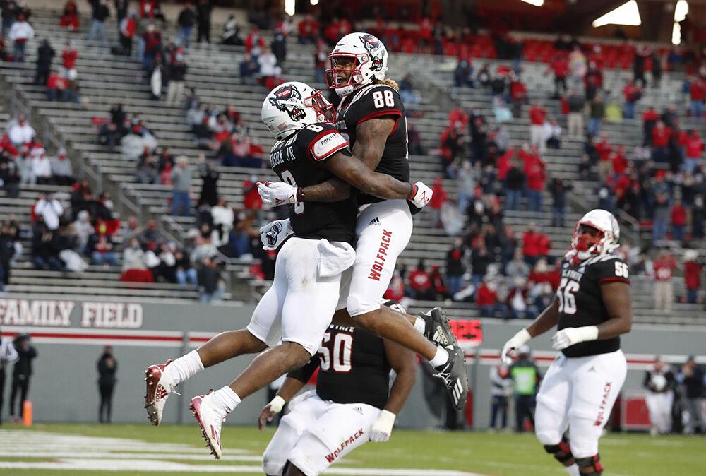 N.C. State running back Ricky Person Jr. (8) celebrates with Devin Carter (88) after scoring on a 20-yard touchdown run during the first half of N.C. State&#8217;s game against Georgia Tech at Carter-Finley Stadium in Raleigh, N.C., Saturday, Dec. 5, 2020.
