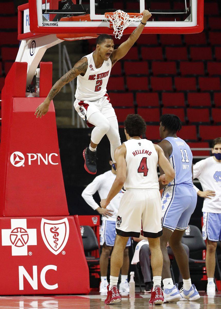 N.C. State's Shakeel Moore (2) celebrates after slamming in two during the first half of N.C. State&#8217;s game against UNC at PNC Arena in Raleigh, N.C., Tuesday, December 22, 2020.