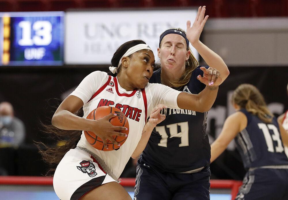 N.C. State's Jada Boyd (5) drives around North Florida's Erin Jones (14) during the first half of N.C. State&#8217;s game against North Florida at Reynolds Coliseum in Raleigh, N.C., Wednesday, Nov. 25, 2020.