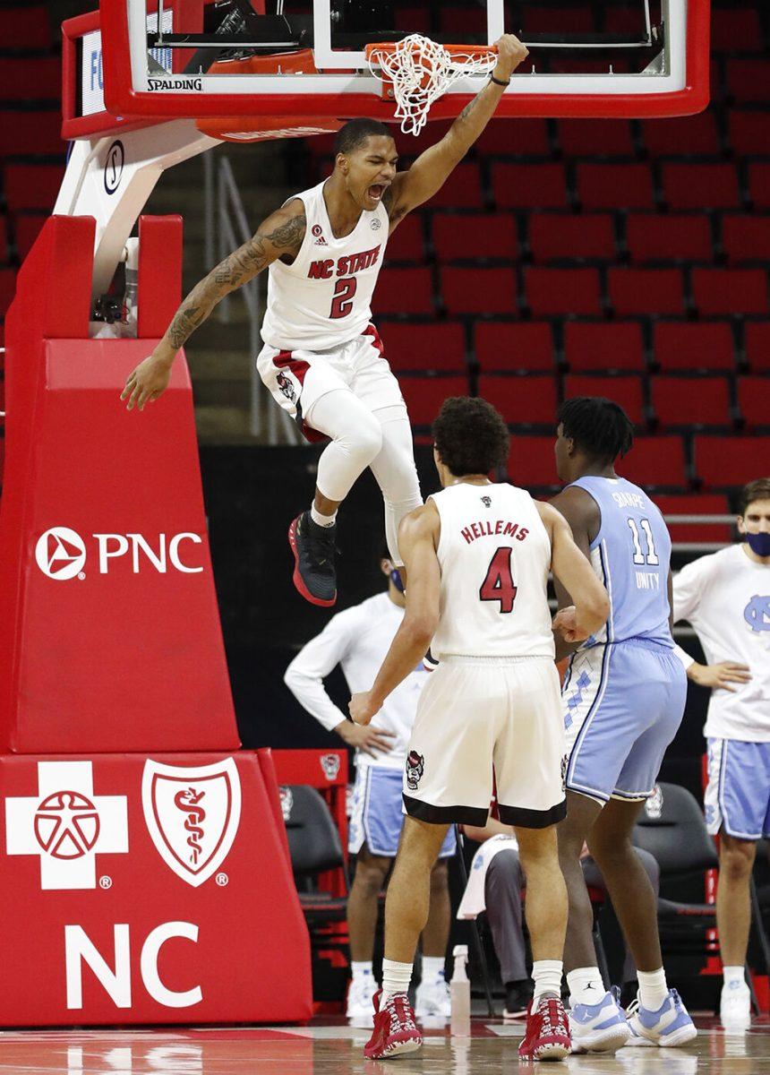 N.C. State's Shakeel Moore (2) celebrates after slamming in two during the first half of N.C. State&#8217;s game against UNC at PNC Arena in Raleigh, N.C., Tuesday, December 22, 2020.