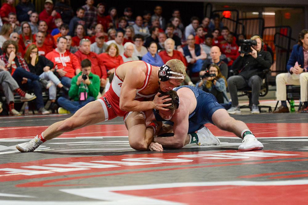 Hayden Hidlay, a 157-pound redshirt junior, fights to get the upper hand against his UNC-CH opponent at the wrestling match on Friday, Feb. 7 at Reynolds Coliseum. The Wolfpack saw record attendence with over 4,300 atendees.