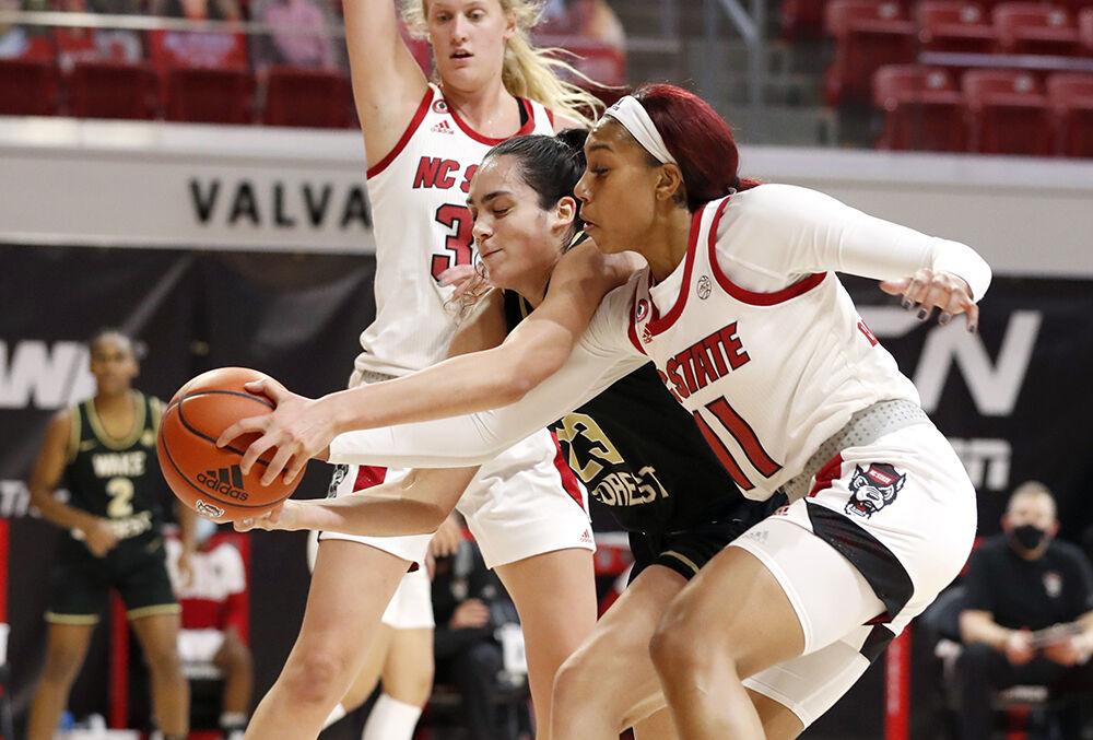 Wake Forest's Christina Morra (23) and NC State's Jakia Brown-Turner (11) go after the ball during the first half of N.C. State&#8217;s game against Wake Forest at Reynolds Coliseum in Raleigh, N.C., Thursday, Dec. 17, 2020.