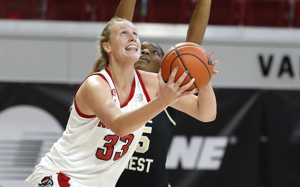 NC State's Elissa Cunane (33) shoots as Wake Forest's Demeara Hinds (25) defends during the second half of N.C. State&#8217;s 79-65 victory over Wake Forest at Reynolds Coliseum in Raleigh, N.C., Thursday, Dec. 17, 2020.