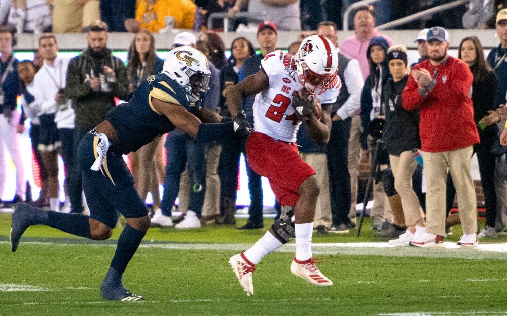 Freshman running back Zonovan Knight pushes past a tackler during NC State's game against Georgia Tech at Bobby Dodd Stadium on Nov. 21, 2019. The Wolfpack lost 28-26.