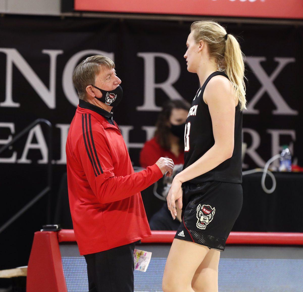 N.C. State head coach Wes Moore talks with Elissa Cunane (33) during the second half of N.C. State&#8217;s 78-47 victory over Miami at Reynolds Coliseum in Raleigh, N.C., Sunday, Dec. 20, 2020.