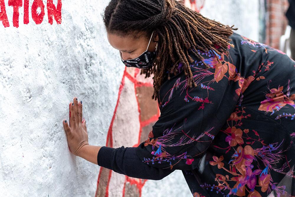 Melanie Flowers, the Student Body President, places her hand covered in paint against the wall of the Free Expression Tunnel after a Student Government protest on Tuesday, Jan. 19, 2021. The event was in protest of the continued employment of Chadwick Seagraves, an NC State employee with alleged ties to the white nationalist group Proud Boys.