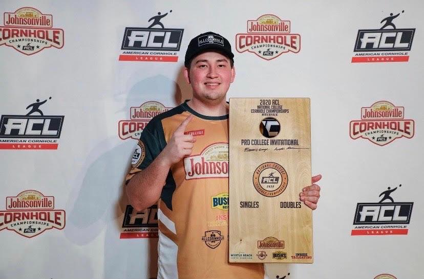 Third-year Draven Sneed poses with Pro College Invitational National College Cornhole Championships award.