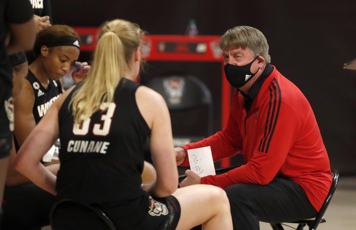 N.C. State head coach Wes Moore talks to his team during a timeout in the first half of N.C. State&#8217;s game against Miami at Reynolds Coliseum in Raleigh, N.C., Sunday, Dec. 20, 2020.