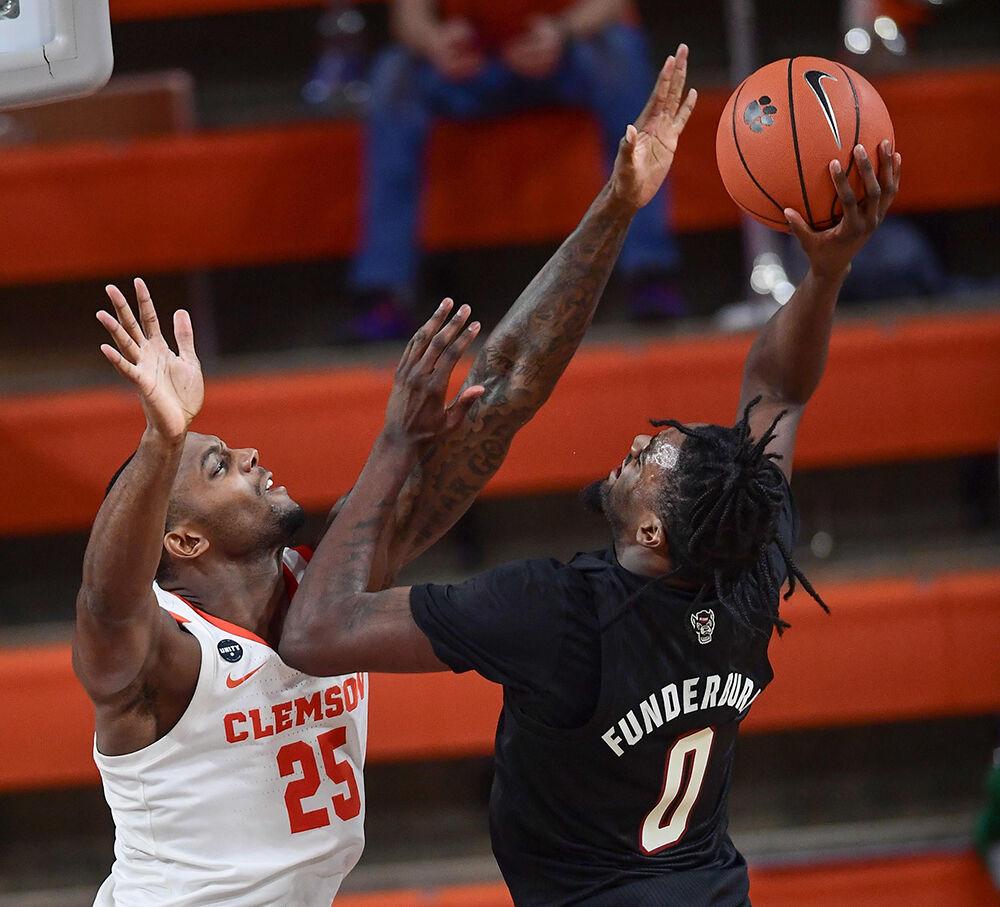 Clemson senior forward Aamir Simms(25) defends NC State forward D.J. Funderburk(0) during the second half Jan 5, 2021; Clemson, South Carolina, USA; at Littlejohn Coliseum. Mandatory Credit: Ken Ruinard-USA TODAY Sports