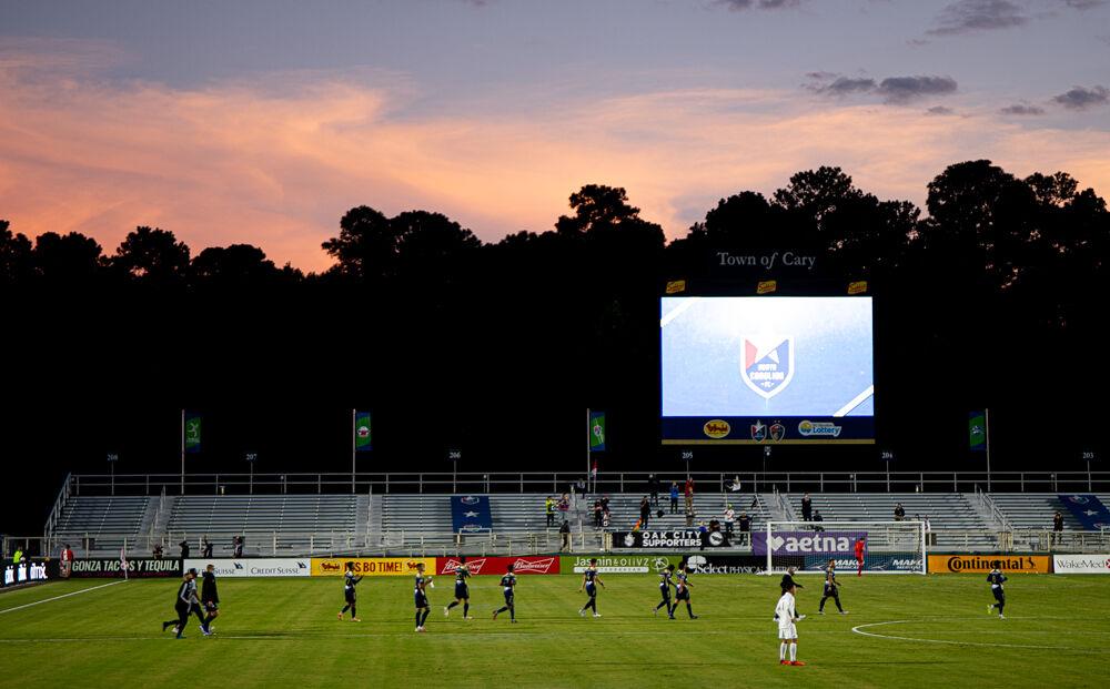North Carolina FC supporters welcome their team onto the field before the game against the Charlotte Independence on Saturday, Oct. 3, 2020 at WakeMed Soccer Park. The game was the first time since the beginning of the coronavirus pandemic that fans were allowed onto stadium grounds. NCFC lost 1-0.