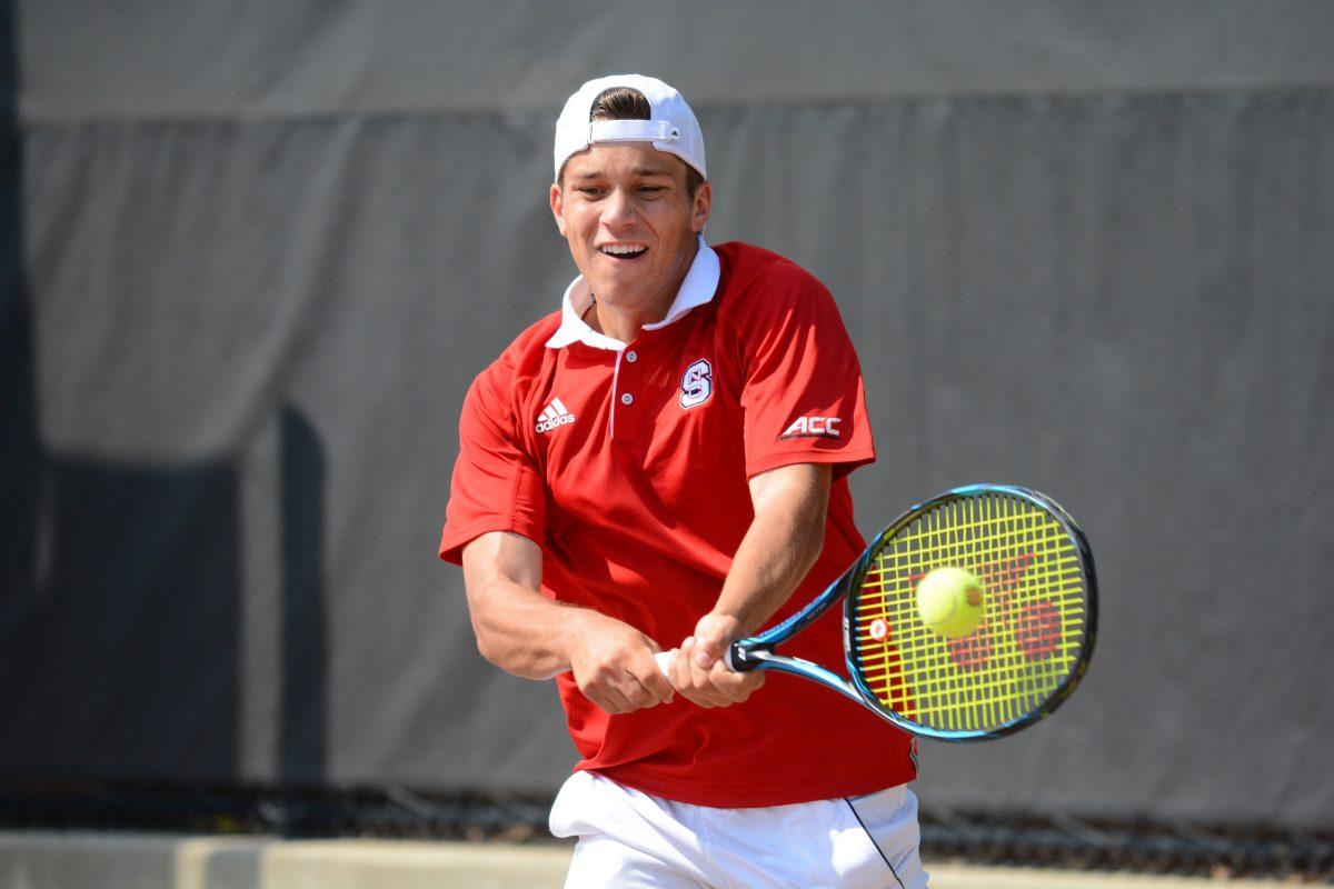 Freshman Alexis Galarneau backhands his opponent's return in a match against Miami University at J.W. Isenhour Tennis Center on April 14, 2017. In a double match along with Michael Ogden, the score ended with 6-2 win. In a single match against Christian Langmo, the score ended with 6-4, 6-1. The Wolfpack won the match against Miami University 5-2.