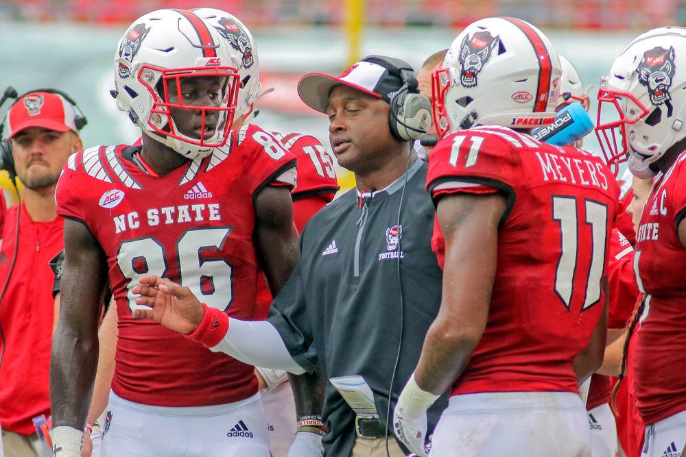 Co-Offensive Coordinator and Wide Receivers Coach George McDonald talks to sophomore wide receiver Emeka Emezie and redshirt junior wide receiver Jakobi Meyers at a timeout during the 28-23 win over Boston College on Saturday, Oct. 6 in Carter-Finley Stadium.&#160;