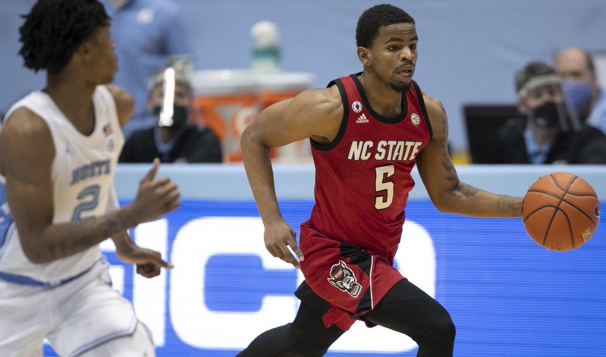 N.C. State's Thomas Allen (5) runs a fast break ahead of North Carolina's Caleb Love (2) in the second half on Saturday, January 23, 2021 at the Smith Center in Chapel Hill, NC.