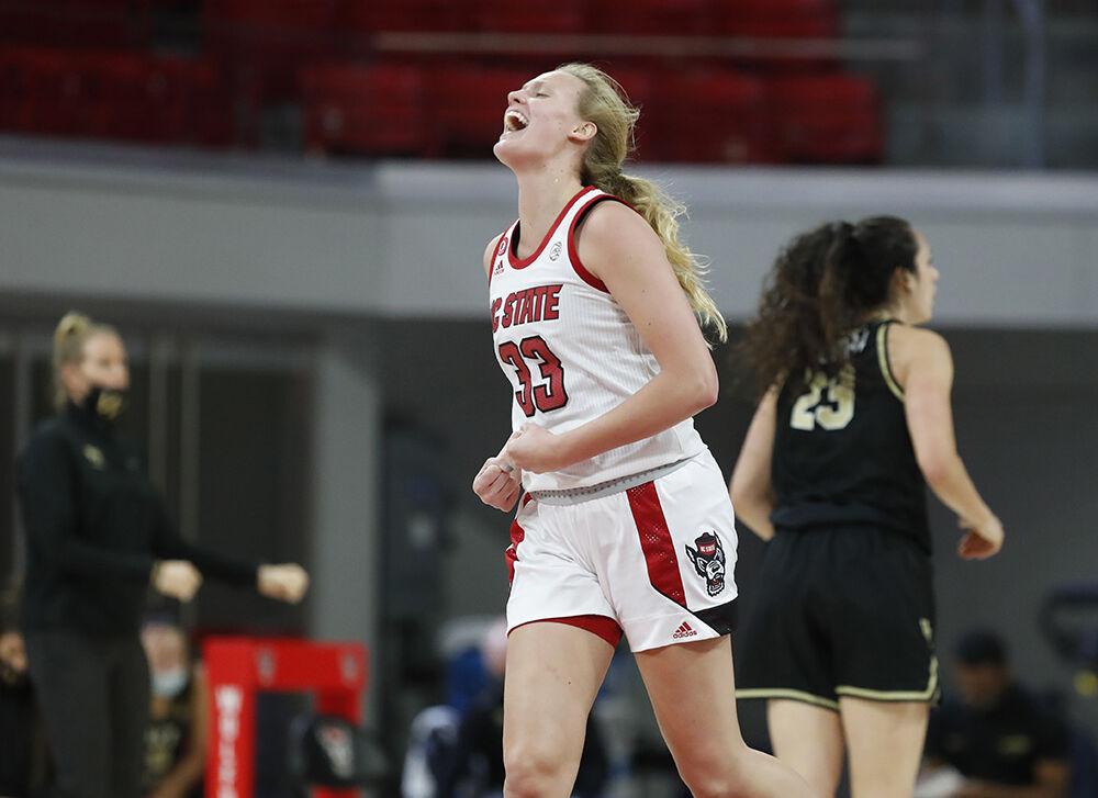 NC State's Elissa Cunane (33) celebrates heading back downcourt after the Wolfpack made a three-pointer during the first half of N.C. State&#8217;s game against Wake Forest at Reynolds Coliseum in Raleigh, N.C., Thursday, Dec. 17, 2020.