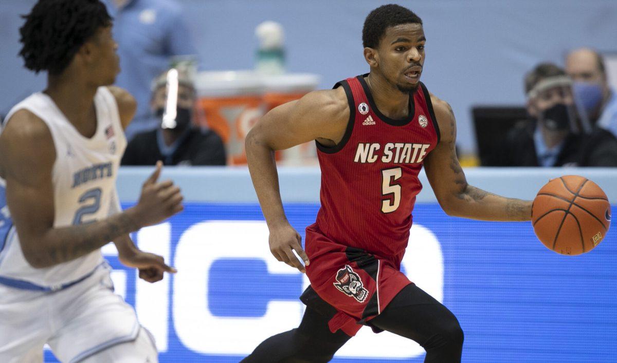 N.C. State's Thomas Allen (5) runs a fast break ahead of North Carolina's Caleb Love (2) in the second half on Saturday, January 23, 2021 at the Smith Center in Chapel Hill, NC.