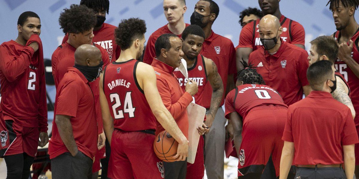N.C. State coach Kevin Keatts huddles with his team during a time-out in the second half against North Carolina on Saturday, January 23, 2021 at the Smith Center in Chapel Hill, NC.