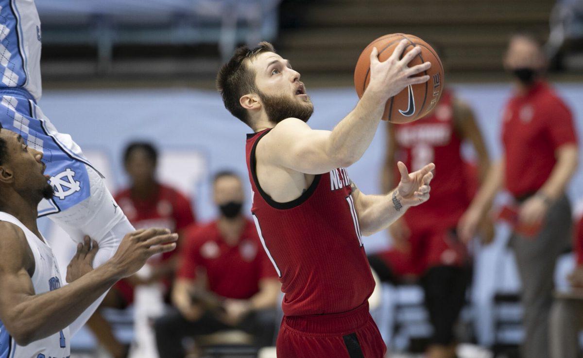 N.C. State's Braxton Beverly (10) breaks to the basket past North Carolina's Leaky Black (1) in the second half on Saturday, January 23, 2021 at the Smith Center in Chapel Hill, NC.