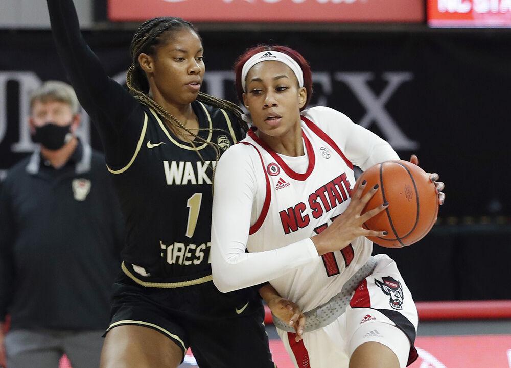 NC State's Jakia Brown-Turner (11) drives by Wake Forest's Anaia Hoard (1) during the second half of N.C. State&#8217;s 79-65 victory over Wake Forest at Reynolds Coliseum in Raleigh, N.C., Thursday, Dec. 17, 2020.