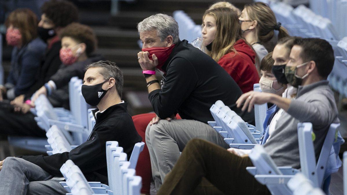 N.C. State athletic director Boo Corrigan, center, watches the second half of the Wolfpack's game against North Carolina on Saturday, January 23, 2021 at the Smith Center in Chapel Hill, NC.