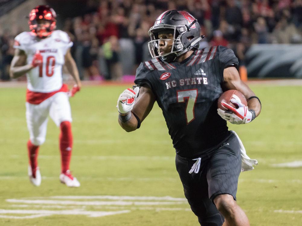 Junior running back Nyheim Hines darts upfield in the 39-25 win over Louisville in Carter-Finley Stadium on Thursday, October 5.